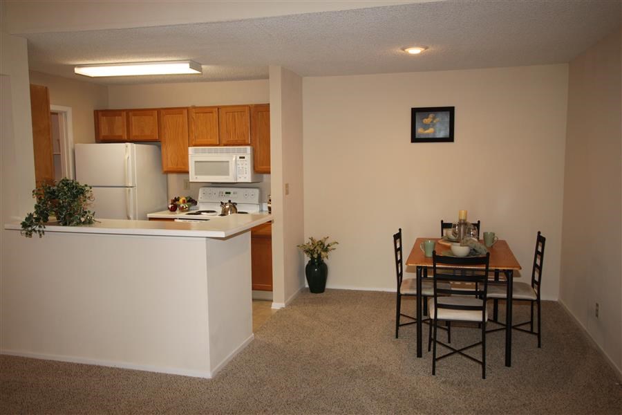 a kitchen and dining room with a table and chairs