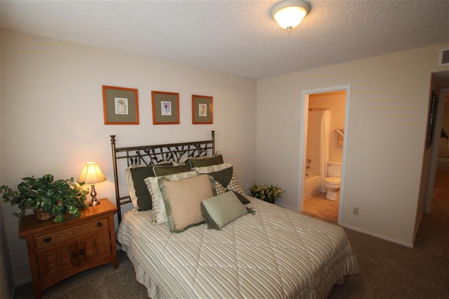 a bedroom with a bed and a night stand