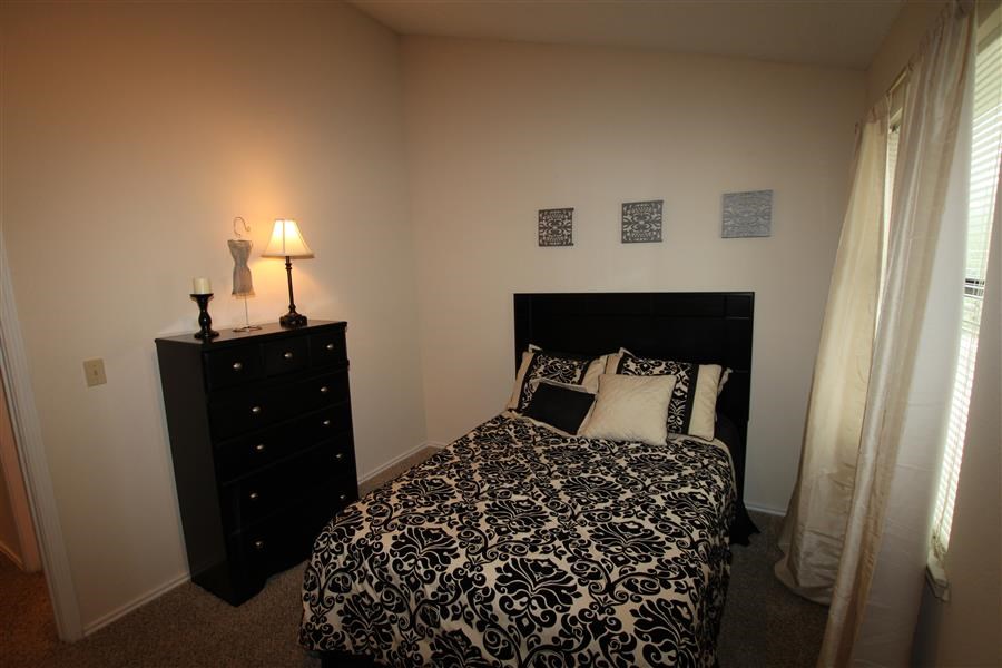 a bedroom with a bed and a dresser