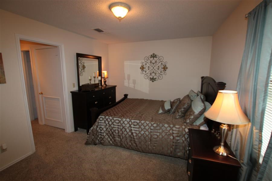 a bedroom with a bed and a dresser