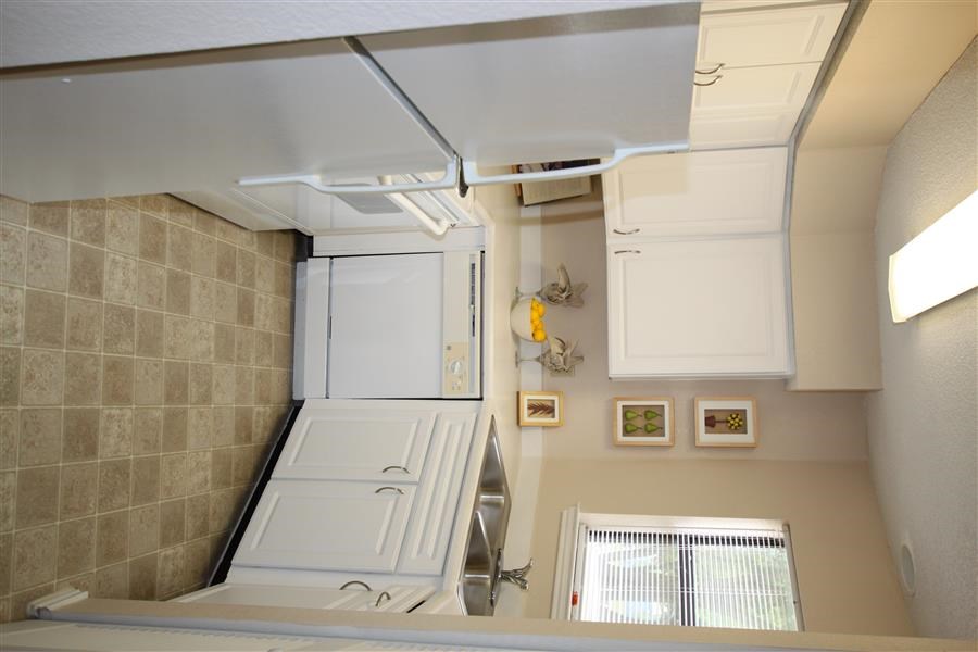 a bathroom with a sink and a refrigerator