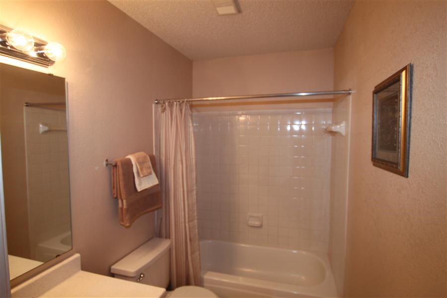 a bathroom with a shower and a toilet and a sink