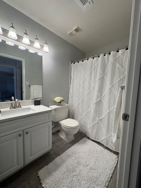 a bathroom with a toilet and a sink and a shower