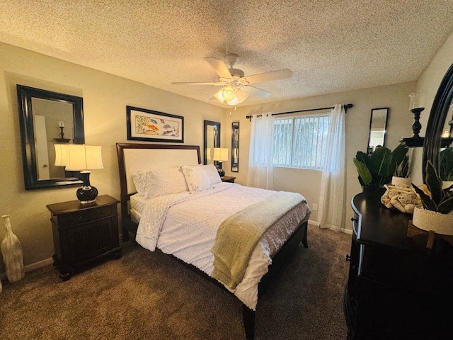 a bedroom with a bed and a ceiling fan