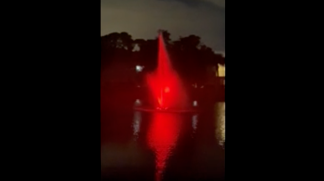 a water fountain with a red light on it