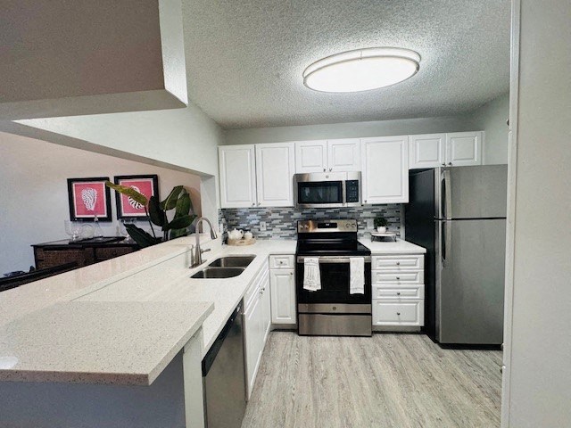 a kitchen with stainless steel appliances and white cabinets