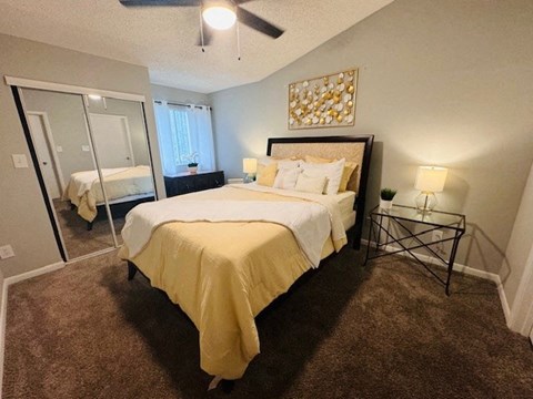 a bedroom with a large bed and a mirror