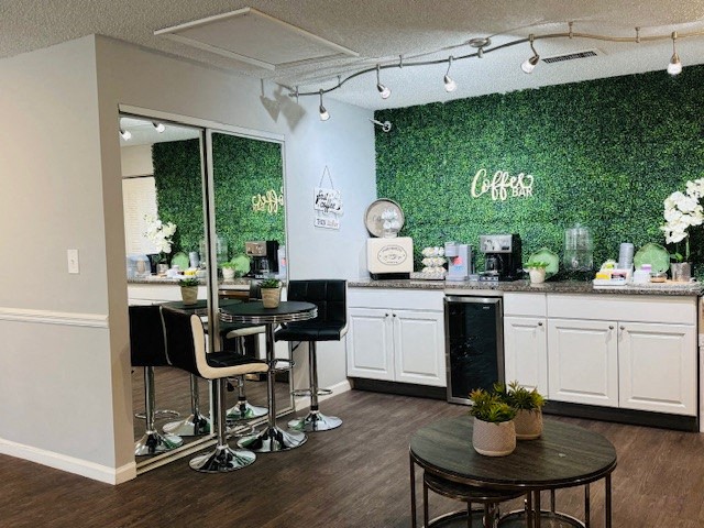 a coffee shop with a green wall and tables