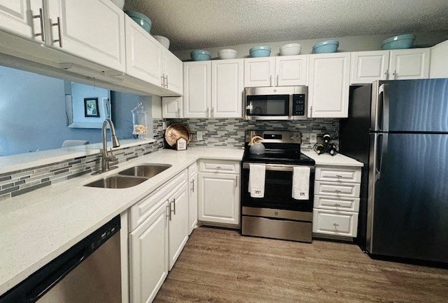 a kitchen with white cabinets and a stove and a refrigerator