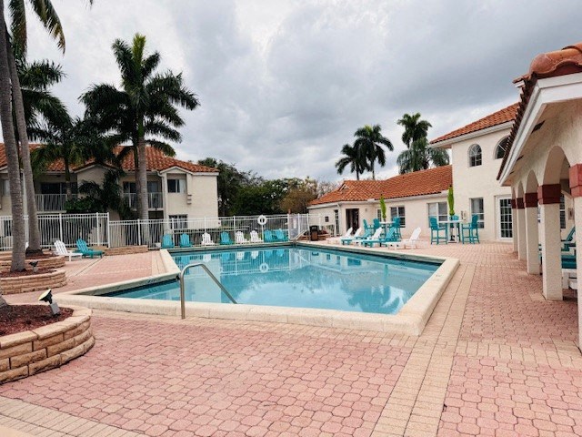 a large swimming pool in front of a building