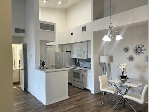 A modern kitchen with a table and chairs.