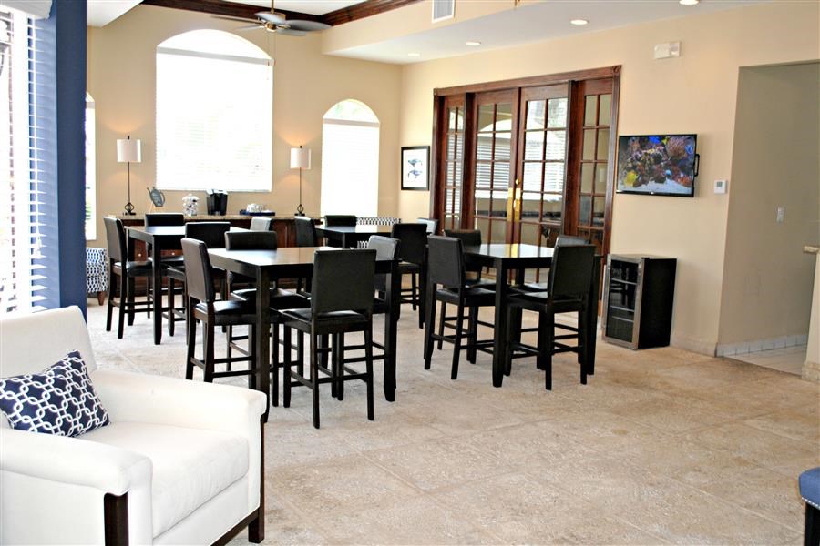 a dining room with tables and chairs in a living room