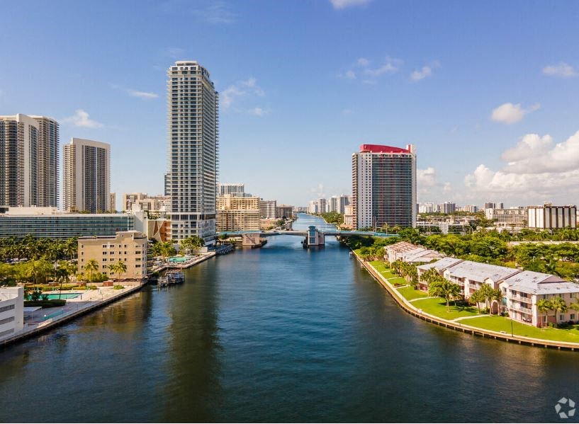 a river running through a city with tall buildings