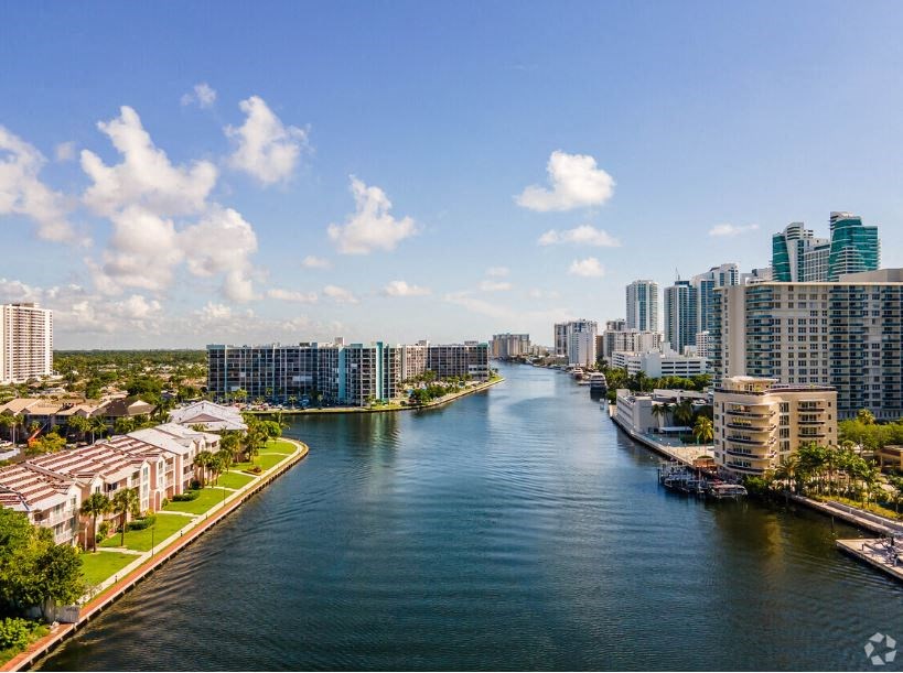 a river running through a city with tall buildings on both sides