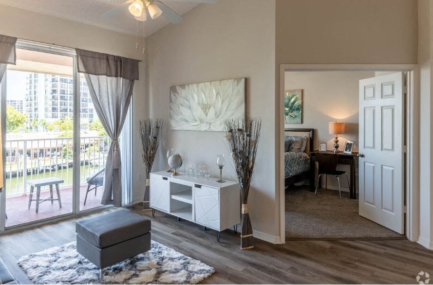 a living room with a couch and a door to a balcony