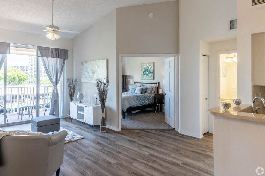 a living room with a bedroom and a balcony