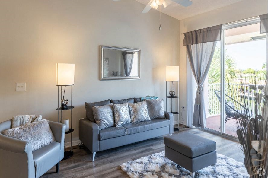 a living room with a couch and a sliding glass door
