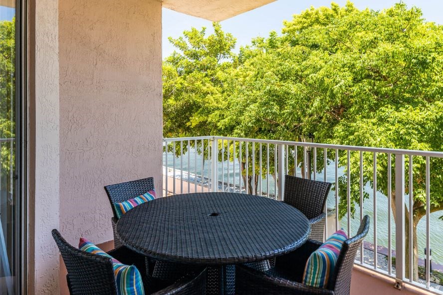 a patio with a table and chairs on a balcony