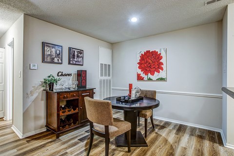 a dining room with a table and chairs next to a doorway