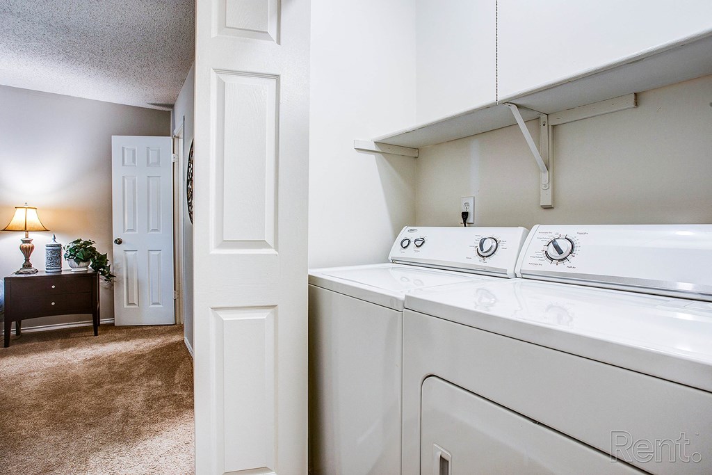 a washer and dryer in a laundry room with an open door