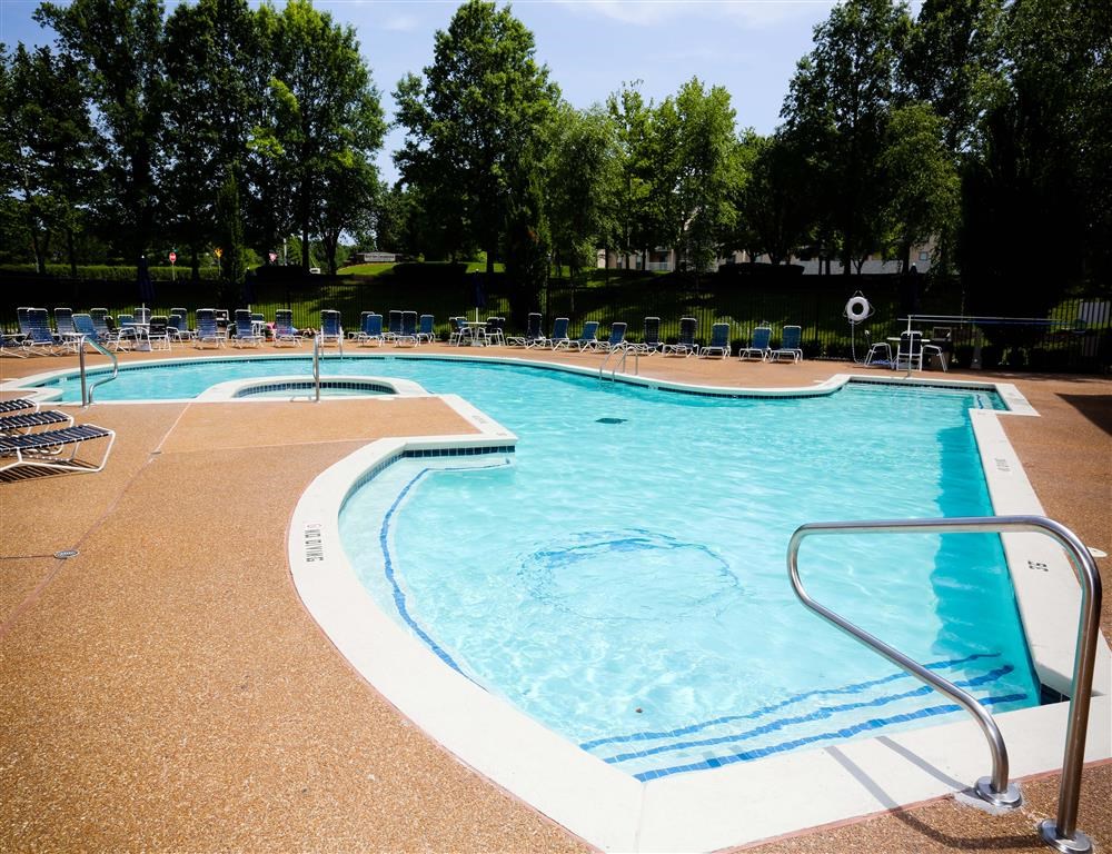 a resort style pool with chairs around it
