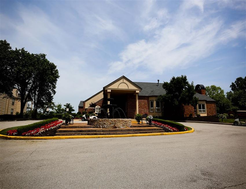 the front entrance of a building with a fountain