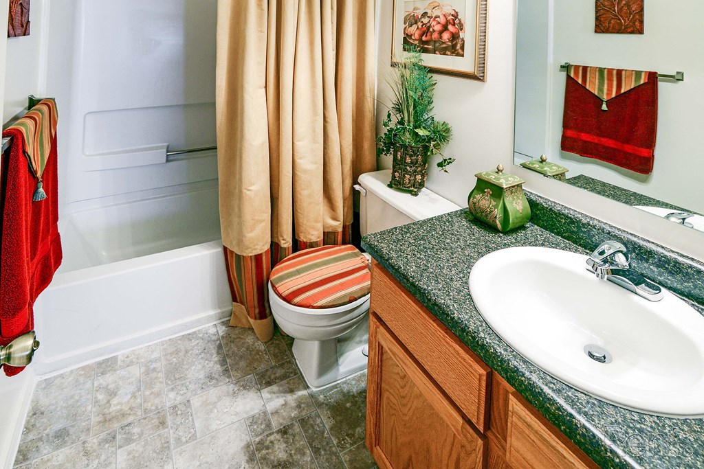 a bathroom with a toilet and a sink and a shower