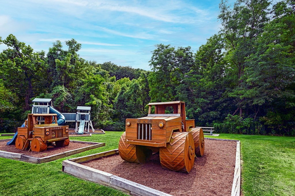 two wooden tractors on display in a park