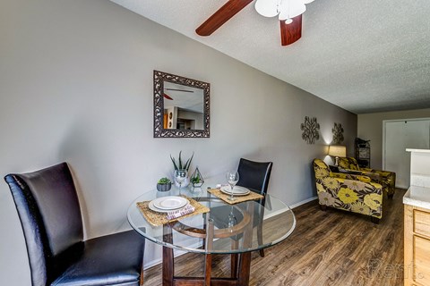 a dining room with a glass table and chairs
