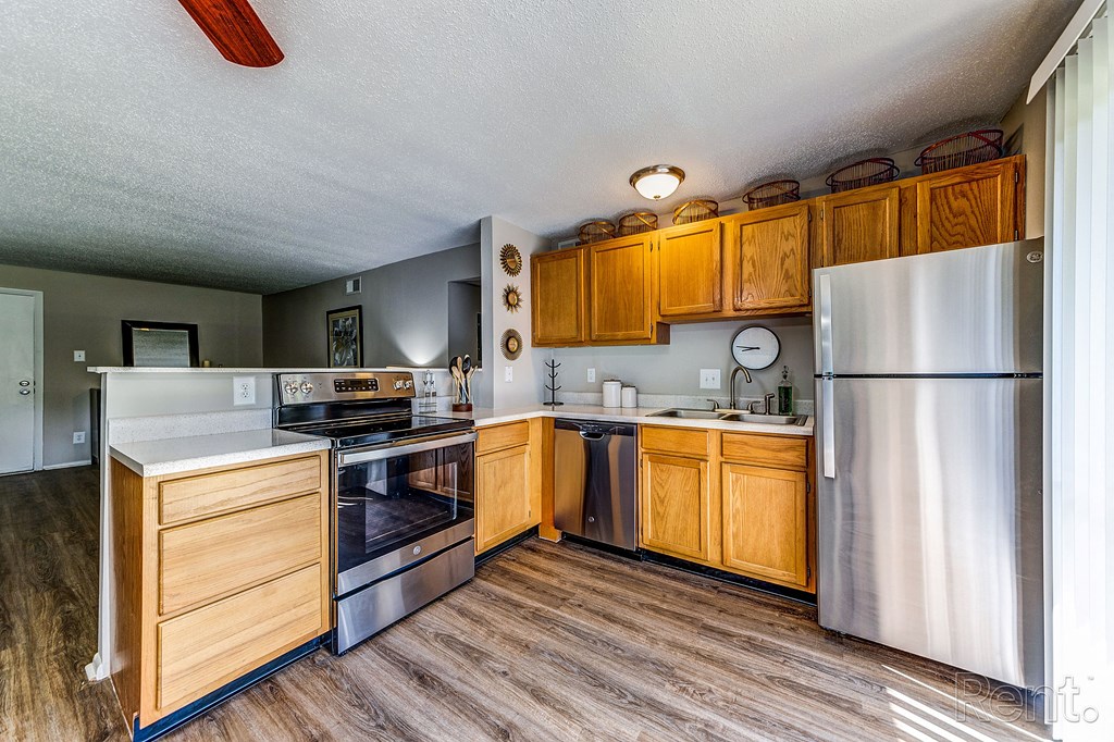 a kitchen with stainless steel appliances and wooden cabinets