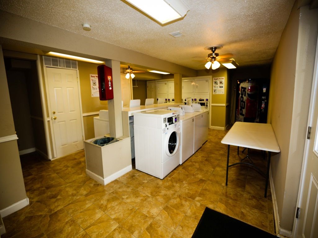 a laundry room with washer and dryer and a table