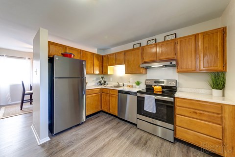a kitchen with stainless steel appliances and wooden cabinets
