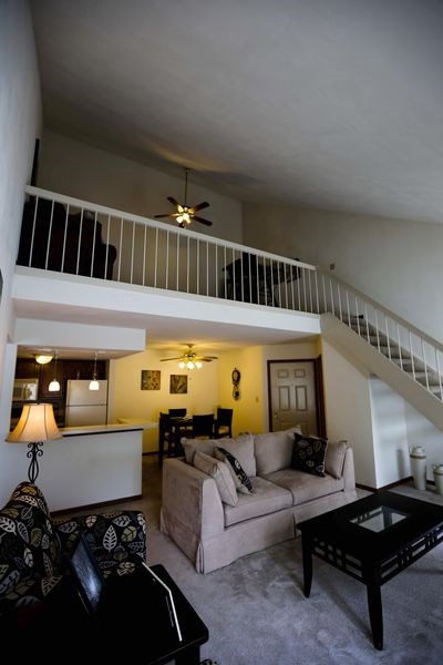 a living room with a couch and a balcony