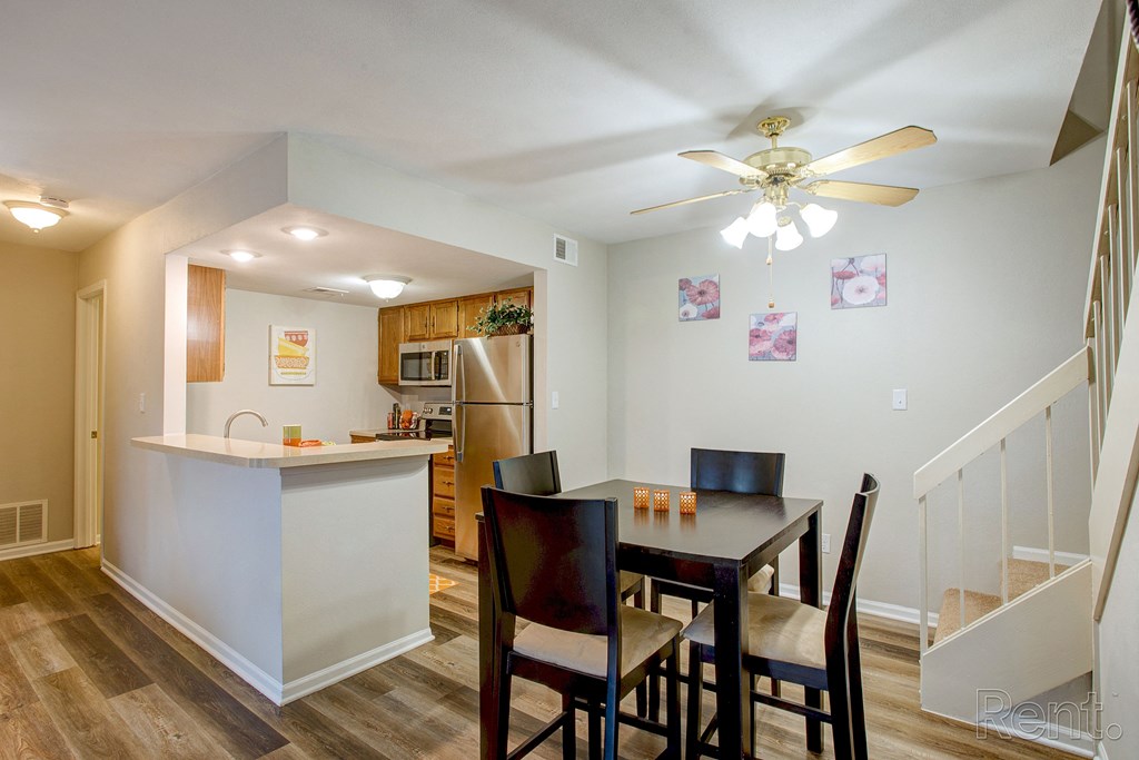 a dining room with a table and chairs and a kitchen