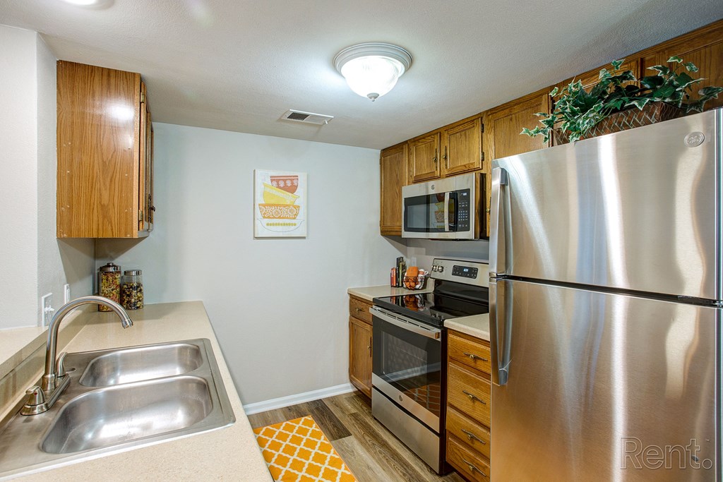 a kitchen with stainless steel appliances and wooden cabinets
