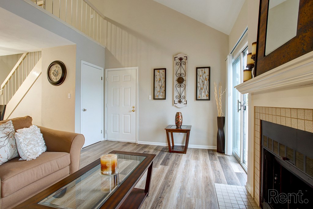 a living room with a couch and a table and a fireplace
