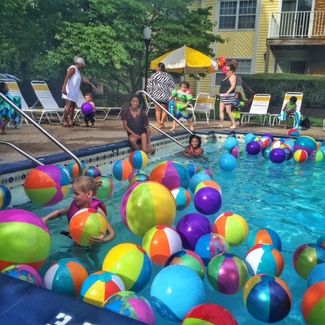 a group of children playing in a pool filled with colorful balls