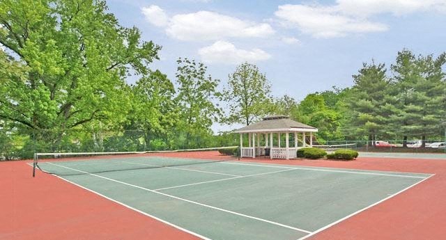 a tennis court with a gazebo