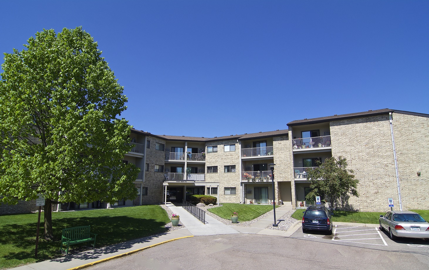an apartment building with cars parked in front of it