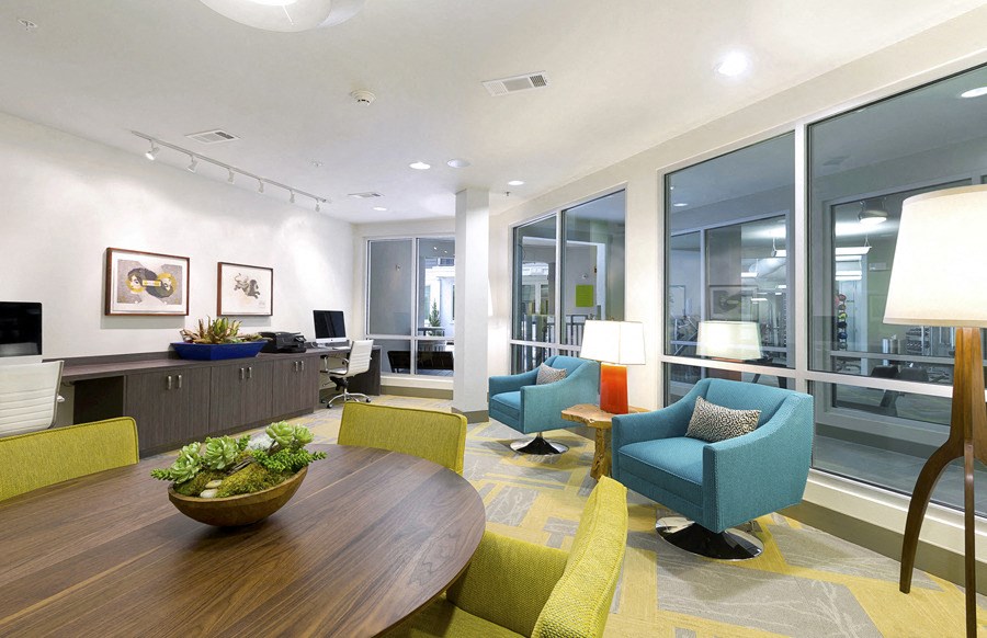 a living room with chairs and a table