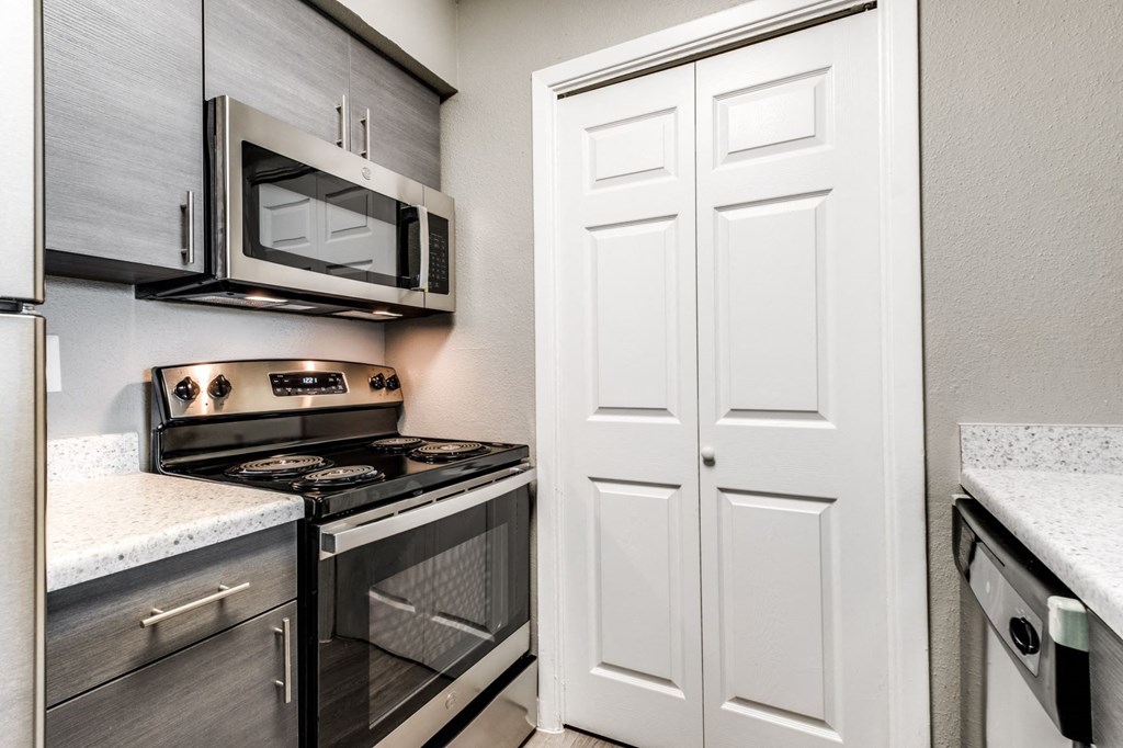 a kitchen with stainless steel appliances and a white door