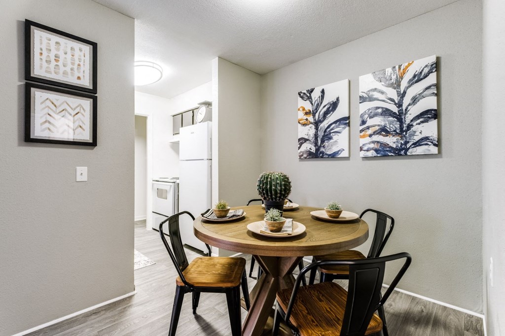 a dining room with a wooden table and chairs