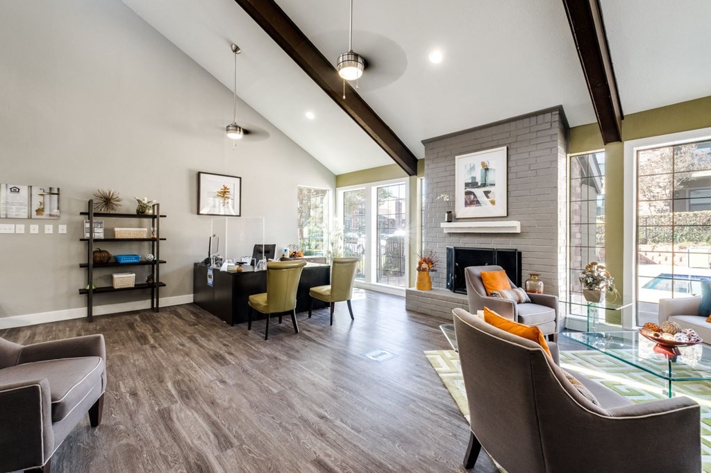 a living room with a fireplace and a table with chairs