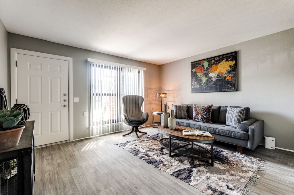 the living room of an apartment with a couch and a chair