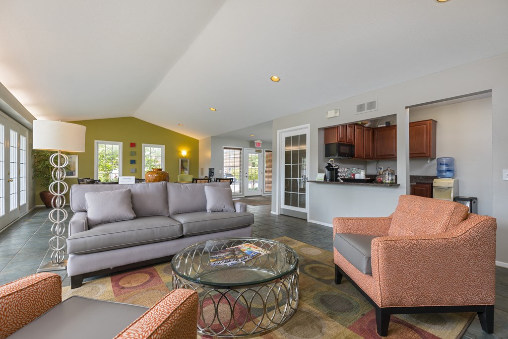 a living room with couches and chairs and a table