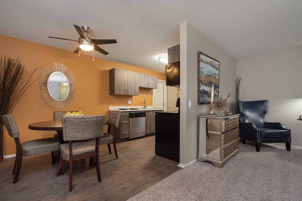 a living room with a dining room table and a kitchen