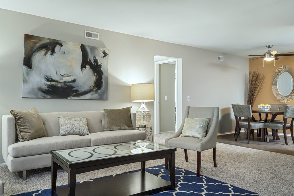 a living room with a couch and chair and a coffee table