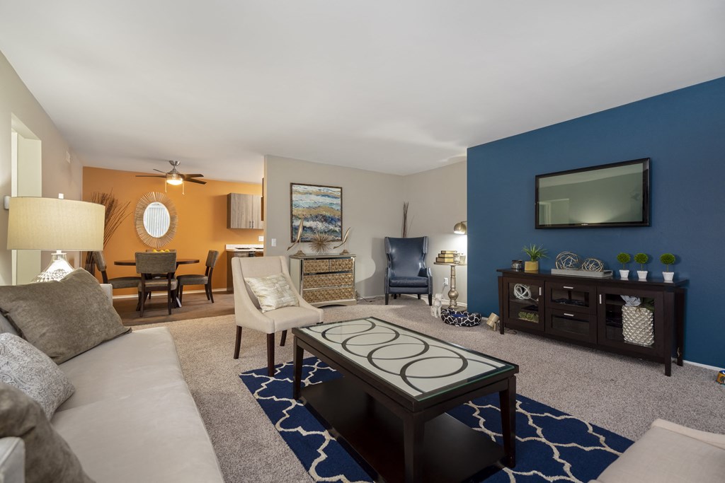 a living room with a blue accent wall and a couch