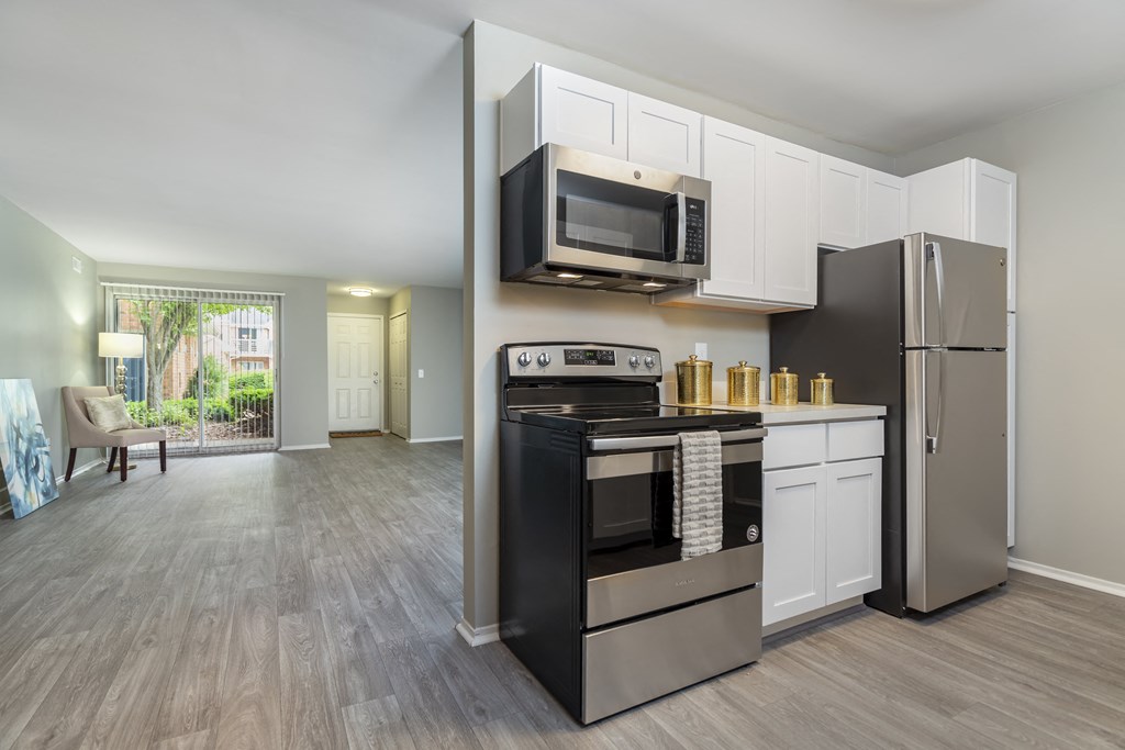 a kitchen with stainless steel appliances and a microwave