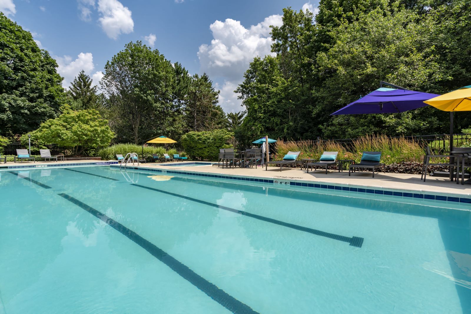 a swimming pool with umbrellas and chairs around it
